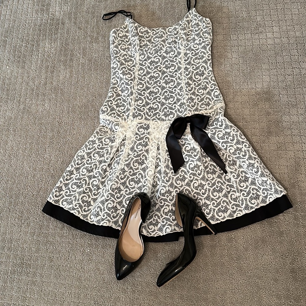 Bebe size small white lace laid over black dress.